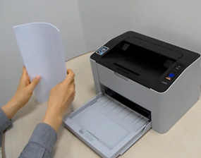 용지함에서 용지를 꺼내 정렬하는 화면