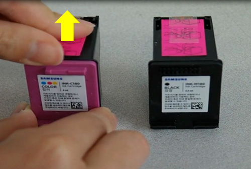 새 잉크 카트리지에 있는 분홍색 당김탭을 잡아 당기는 화면