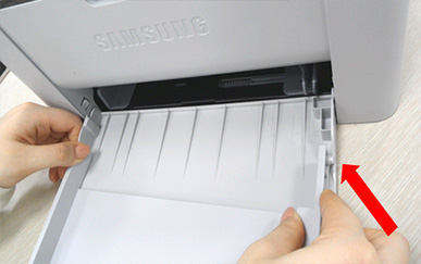 용지함 가이드를 오른쪽 부분을 구멍에 밀어서 끼우는 화면